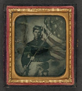Unidentified soldier in Union uniform with bayoneted musket in front of American flag