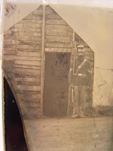 Corporal Sidney S. Goodridge of Company K, 20th Massachusetts Infantry Regiment and Company B, 4th Massachusetts Heavy Artillery Regiment with bayoneted musket in front of shebang at Camp Benton, near Edwards Ferry, Maryland (between 1861 and 1865; LOC: LC-DIG-ppmsca-27385)