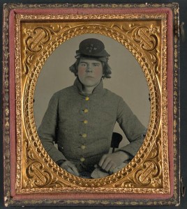 Unidentified young soldier in Confederate uniform with North Carolina state seal buttons and North Carolina Volunteers hat (between 1861 and 1865; LOC: LC-DIG-ppmsca-31291)