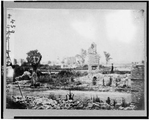 Ruins at Hampton, Virginia showing chimneys, and man standing (between 1861 and 1865; LOC: LC-USZ62-103066)