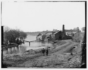 Richmond, Va. View of the Tredegar Iron Works, with footbridge to Neilson's Island (1865 April; LOC: LC-DIG-cwpb-04035 )