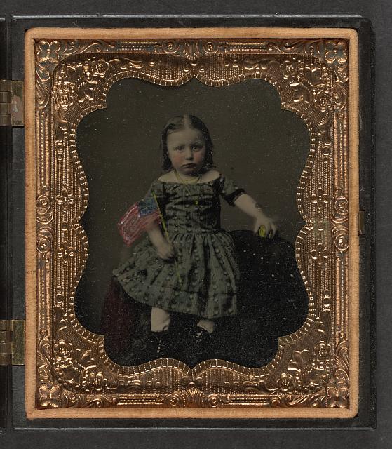 Unidentified girl in dress holding American flag and ball (between 1860 and 1870; LOC: LC-DIG-ppmsca-36923) Unidentified girl in dress holding American flag and ball (between 1860 and 1870; LOC: LC-DIG-ppmsca-36923)