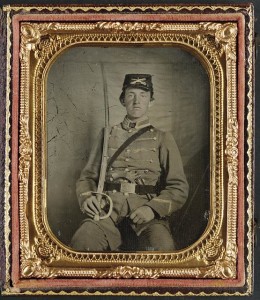 Private David M. Thatcher of Company B, Berkeley Troop, 1st Virginia Cavalry Regiment, in uniform and Virginia sword belt plate with Adams revolver and cavalry sword (between 1861 and 1865; LOC:  LC-DIG-ppmsca-32680)