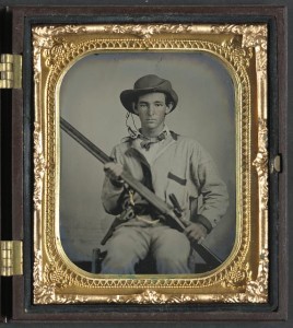[Unidentified soldier in Confederate pullover hunting-style shirt with dark military-type trim with double barrel shotgun, revolver, and side knife] (between 1861 and 1865; LOC: LC-DIG-ppmsca-32605)