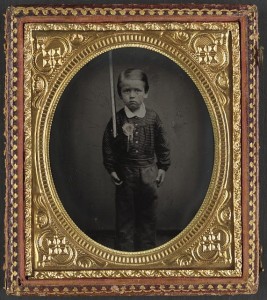 Unidentified young boy wearing secession badge and holding a rifle (between 1861 and 1865; LOC:  LC-DIG-ppmsca-34266)