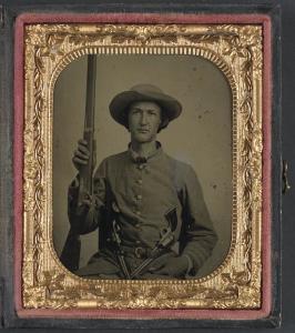 Unidentified soldier in Confederate infantry uniform with model 1842 musket and two Colt revolvers (between 1861 and 1865; LOC: LC-DIG-ppmsca-32591)