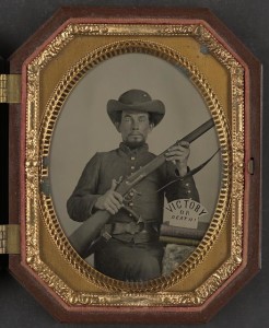 Unidentified soldier in Confederate uniform with musket, knife, and sign reading Victory or Death! atop two books ([United States], [between 1861 and 1865] ; LOC: LC-DIG-ppmsca-38370)