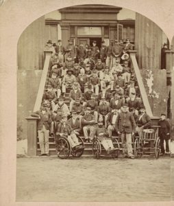 Group of veteran soldiers, National Home for Disabled Volunteer Soldiers, near Fort Monroe, Va., Capt. P.T. Woodfin, Governor (Philadelphia, Pa. : E.H. Hart, Copying, Landscape and Stereoscopic Photographer, 911 Arch Street, [between 1870 and 1880]; LOC: https://www.loc.gov/item/2015649047/)