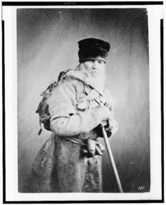 Bearded man, standing, three-quarter length, wearing backpack, with walking stick, Russia (between ca. 1880 and 1924; LOC: https://www.loc.gov/item/93506572/)