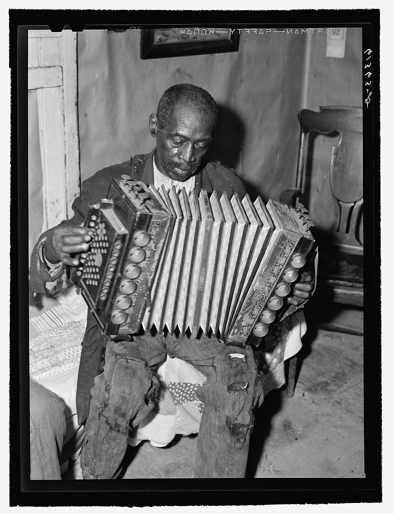 John Dyson, FSA (Farm Security Administration) borrower, playing the accordion. He was born into slavery over eighty years ago. Saint Mary's County, Maryland (1940 Sept.; LOC: https://www.loc.gov/item/fsa2000041990/PP/)